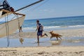 Man running with a dog on Frankston Beach Royalty Free Stock Photo