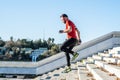 Man running down a flight of stairs and listening to music Royalty Free Stock Photo