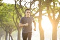 Man running in the forest on foggy at spring morning