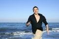 Man running happy on the blue summer beach Royalty Free Stock Photo