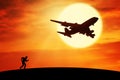 Man running on the hill with flying plane Royalty Free Stock Photo