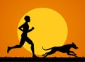 Man running jogging training exercising with his dog at sunset