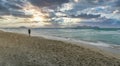 Man running on a lonely beach at sunset on a cloudy day, Playa de Muro, Palma de Mallorca, Balearic Islands, Spain, panoramic Royalty Free Stock Photo