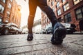 Man running at New York City street at sunset time. Men`s feet with sport sneakers outdoors.