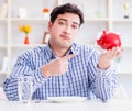 Man running out of money in restaurant and using savings from pi Royalty Free Stock Photo