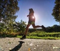 Man running quickly along country lane. Fit and body care Royalty Free Stock Photo