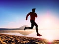 Man running at seaside twilight time. Runner athlete running at seaside. Sportsman fitness silhouette Royalty Free Stock Photo