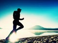 Man running at seaside twilight time. Runner athlete running at seaside. Sportsman fitness silhouette Royalty Free Stock Photo