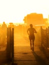 A man running at sunset on the edge of Ondina beach in Salvador, Bahia, Brazil