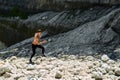 Man Running Up Rocky Hill, Exercising During Outdoor Workout. Sport