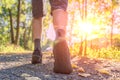 Man is running or walking at sunset. View on legs and feet from behind Royalty Free Stock Photo