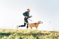 Man runs with his beagle dog. Morning Canicross exercise concept image Royalty Free Stock Photo