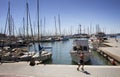 Man runs by Palma de Mallorca marina. Many yachts parked. It`s a