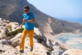 Man runs on a rocks against a blue sea Royalty Free Stock Photo