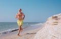 Man runs on the sea surf line barefoot Royalty Free Stock Photo