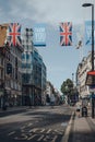 Man runs on sidewalk of empty New Oxford Street, London, UK, decorated with Thank You banners and flags Royalty Free Stock Photo