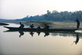 Man runs a wooden boat on the river, Nepal, Chitwan National Park, Royalty Free Stock Photo