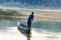 Man runs a wooden boat on the river, Nepal, Chitwan National Park, Royalty Free Stock Photo