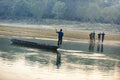 Man runs a wooden boat on the river, Nepal, Chitwan National Park, Royalty Free Stock Photo