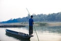 Man runs a wooden boat on the river, Nepal, Chitwan National Park, Royalty Free Stock Photo