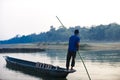 Man runs a wooden boat on the river, Nepal, Chitwan National Park, Royalty Free Stock Photo