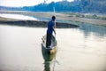 Man runs a wooden boat on the river, Nepal, Chitwan National Park, Royalty Free Stock Photo