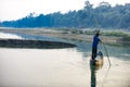 Man runs a wooden boat on the river, Nepal, Chitwan National Park, Royalty Free Stock Photo