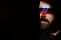 Man with Russian flag blindfold on black background, Russian propaganda closed people& x27;s eyes concept.