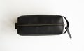 Man's black leather personal cosmetic bag or pouch for toiletry accessory. Style, retro, fashion, vintage and Royalty Free Stock Photo