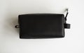 Man's black leather personal cosmetic bag or pouch for toiletry accessory. Style, retro, fashion, vintage and Royalty Free Stock Photo