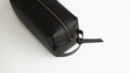 Man's black leather personal cosmetic bag or pouch for toiletry accessory. Style, retro, fashion, vintage and Royalty Free Stock Photo