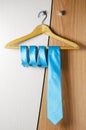 A man`s blue tie hangs on the door of the chiffonier. The concept of a successful man`s style Royalty Free Stock Photo