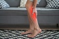 The man`s calf muscle cramped, massage of male leg at home