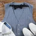 Man`s classic clothes outfit flat lay with formal shirt, vest, bowtie, shoes.