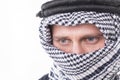 Man's face covered with Arab scarf
