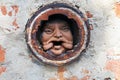 Man`s face in hole at brick wall in Melbourne. Royalty Free Stock Photo