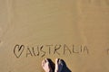 Man`s Feet on Beach Sand with a Carved Love Australia.