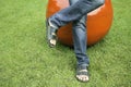 Man`s feet in black sandals on grass