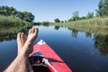 Man's feet over canoe.