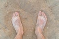 Man`s feet on sandy beach at summer. Royalty Free Stock Photo