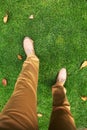 Man's feet in shoes on the grass.