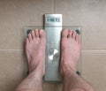 Man`s feet on weight scale - Diabetes