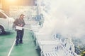 The man`s fogging to eliminate mosquito for preventing spread dengue fever and zika virus Royalty Free Stock Photo