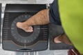 Man`s foot on a pressure platform for the biomechanical study of the tread of the feet