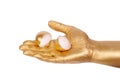 Golden hand holding eggshell on a white background Royalty Free Stock Photo