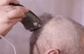 A man is cut hair on his head.The man`s hairstyle in hairdressing salon Royalty Free Stock Photo