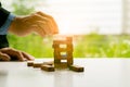 Man`s hand adding the last missing wooden block into place. Business success concept. Planning, risk and strategy in business, bus Royalty Free Stock Photo