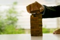 Man`s hand adding the last missing wooden block into place. Business success concept. Planning, risk and strategy in business, bus Royalty Free Stock Photo