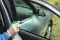 Man`s hand applies liquid to clean the windshield of the car window. Royalty Free Stock Photo