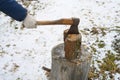 Man`s hand with an axe chopping wood Royalty Free Stock Photo